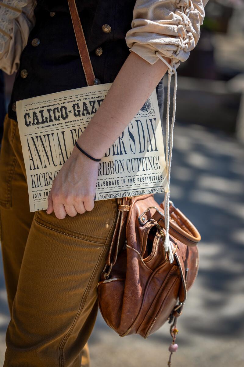 A participant holds the Calico Gazette daily newspaper.