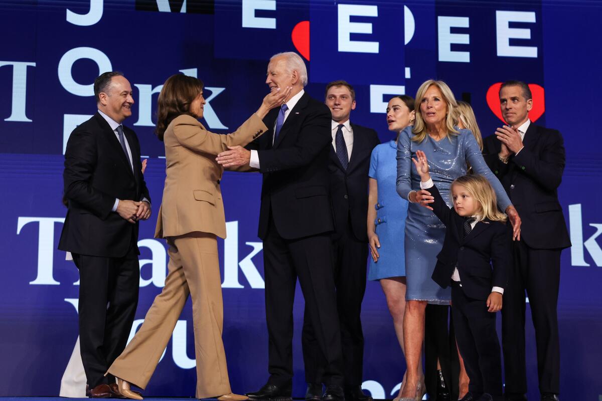 Vice President Kamala Harris embraces Biden after his speech Monday night.