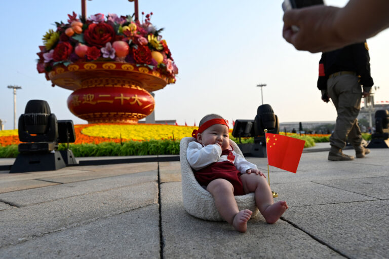 Woman Photographs Infant