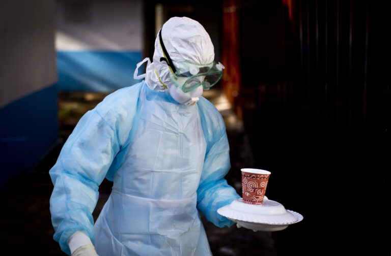 A medical worker in full protective equipment