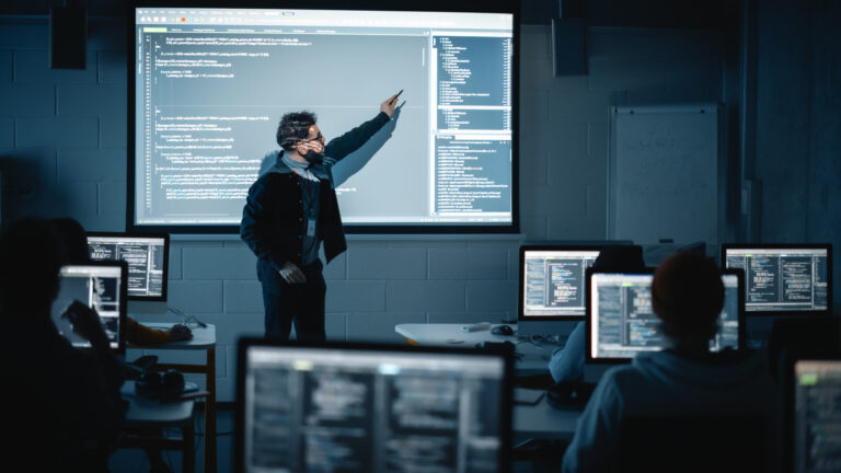  students learning to code on computers