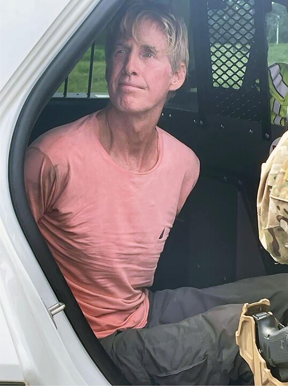 Photo of Ryan Wesley Routh after arrest shows him looking calm in back of police car after allegedly attempting to ass@ssinate Trump