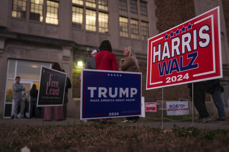 Harris and Trump signs