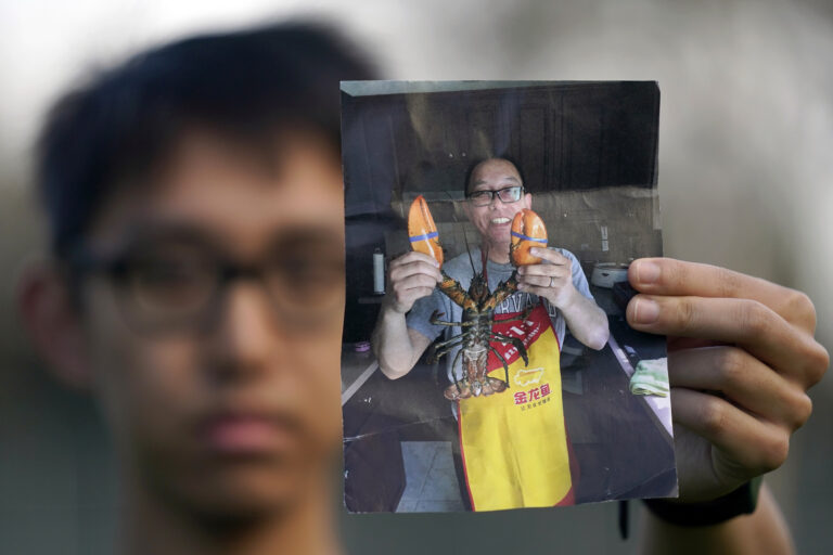 Harrison Li holds up photo of father