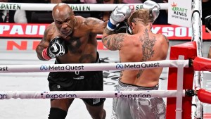 Mike Tyson (in black short) and Jake Paul (in silver short) exchange punches during their heavyweight world titles of the Premiere Boxing Championship on Friday night at AT&T Stadium in Arlington, Texas, United States on November 15, 2024