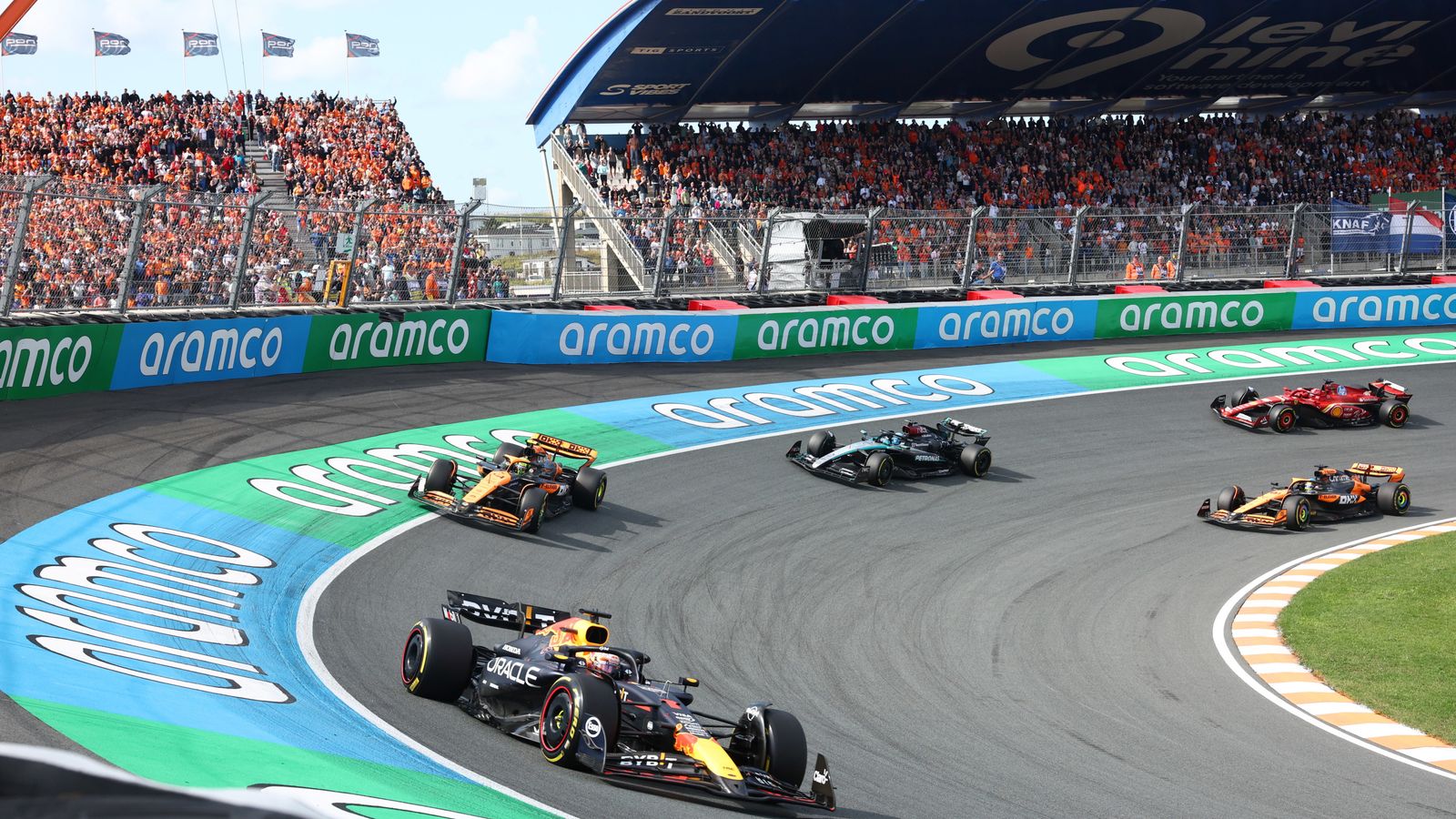 CIRCUIT ZANDVOORT, NETHERLANDS - AUGUST 25: Max Verstappen, Red Bull Racing RB20, leads Lando Norris, McLaren MCL38, George Russell, Mercedes F1 W15, and Oscar Piastri, McLaren MCL38 during the Dutch GP at Circuit Zandvoort on Sunday August 25, 2024 in North Holland, Netherlands. (Photo by Alastair Staley / LAT Images)